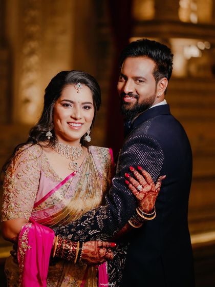 A happy couple portrait from the reception. The bride's makeup is soft yet glamorous, with beautiful waves in her hair.
