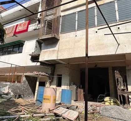 The site before construction, filled with debris. This image provides a stark contrast to the finished luxury residence.