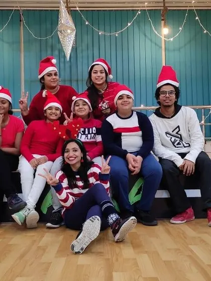 Posing for the camera during our festive Christmas Eve session. The studio is decorated with lights, creating a warm and cheerful atmosphere for everyone.