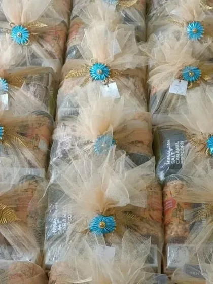 Consistency is key for large orders. Here you can see rows of identical welcome hampers, each perfectly wrapped and ready to make a great impression on your wedding guests.
