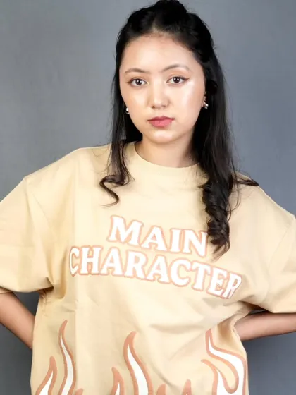 A clean and minimal makeup look for a casual t-shirt brand shoot. The focus here is on fresh skin, groomed brows, and a hint of color on the lips, creating a relatable and effortlessly cool 'main character' vibe.