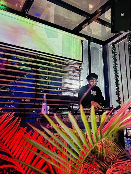 Surrounded by cool decor and tropical plants, I am laying down tracks for a club night. One song is all it takes to bring back a thousand memories.