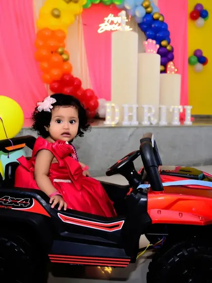 Kids' parties are all about fun. Here, the birthday girl enjoys her toy car, providing a great opportunity for a playful and colorful photograph that adds variety to the event album.