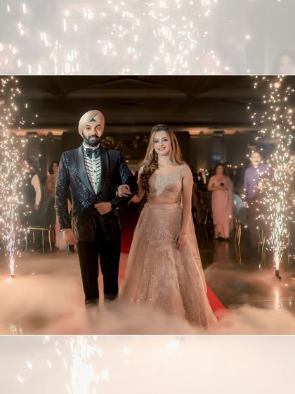 A fairytale entrance for Simran and Sanjit. They walk through a path of cold pyrotechnics and low-lying fog, creating a dreamy and cinematic moment.