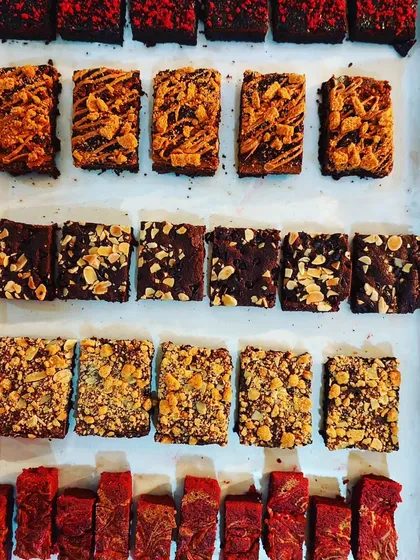 A top-down view of various brownies from our baking diploma course. We teach you how to make everything from classic fudgy brownies to red velvet and nut-topped variations.