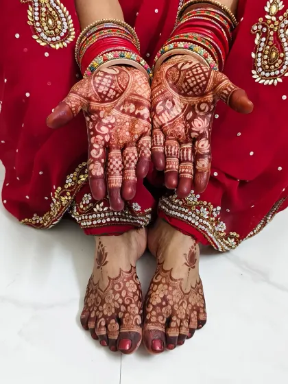 My mother's hands and feet, beautifully adorned with mehndi for the Chhath Puja festival.