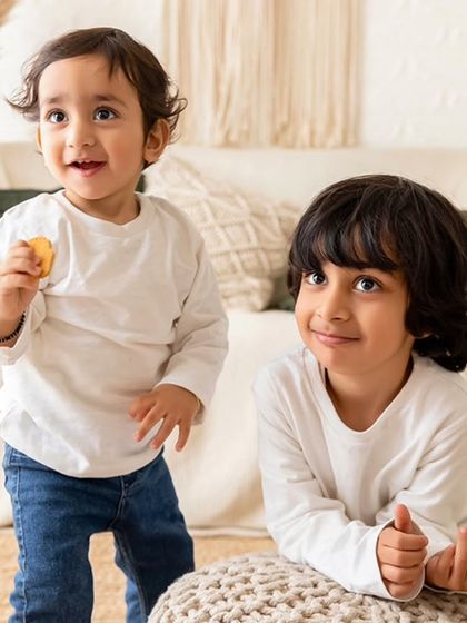A candid shot of two brothers playing and eating biscuits during their family session. I believe in capturing these real, unposed moments that show their personalities.