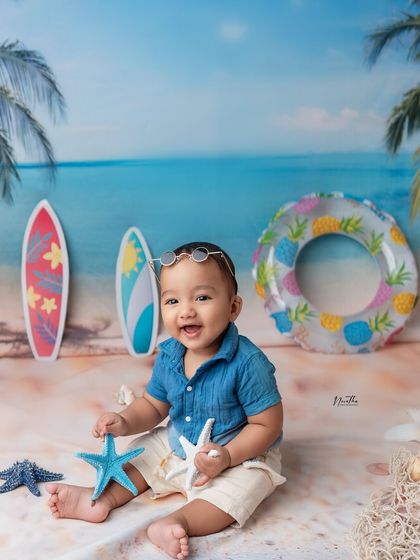 A fun beach-themed studio shoot! We can bring the seaside to the studio with a custom backdrop and fun props like surfboards and starfish.