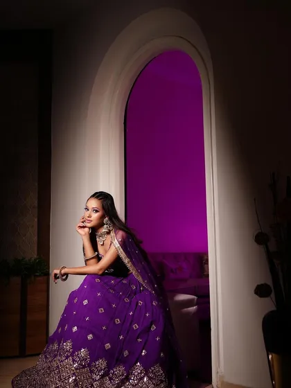 Dazzling in purple and shining bright. This look is all about sparkle, with glittery eyes and shiny lips, perfect for a night of festivities.