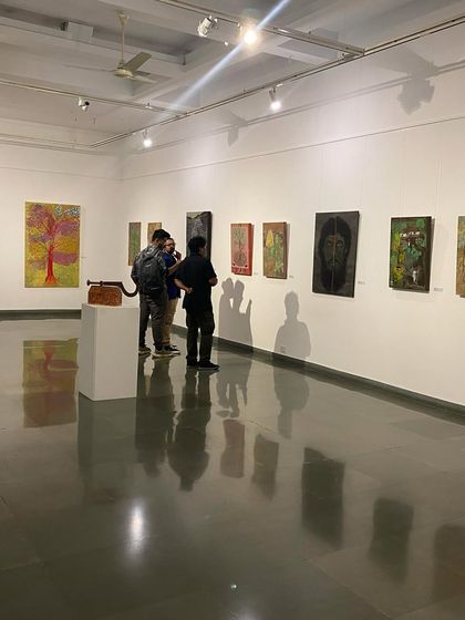 Visitors contemplating the different styles of the mother and son.