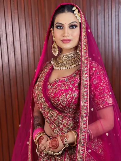 A full portrait of this stunning bride in her pink lehenga. The makeup is bold and confident, just like her.