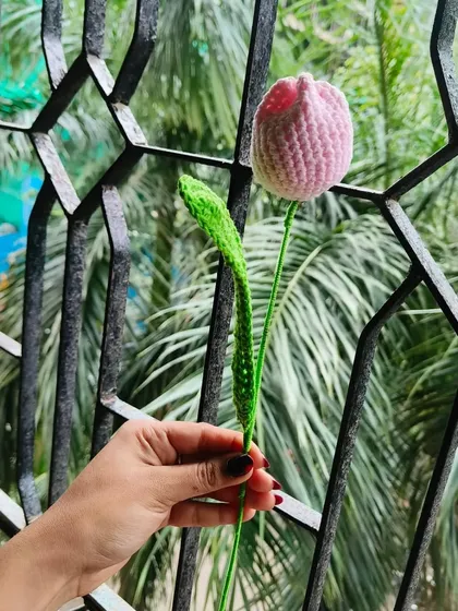 My classic pink crochet tulip. The stem is flexible, and the leaf adds a realistic touch to this beautiful handmade flower.