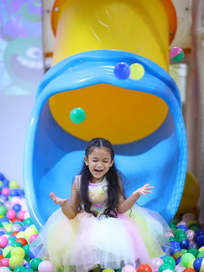 The pure delight of being showered with balls at the bottom of our tube slide during a butterfly-themed birthday party.