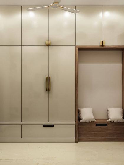 Another versatile storage solution, this wardrobe unit includes a cozy seating nook with built-in shoe storage. The combination of off-white and wood finishes adds warmth and sophistication.