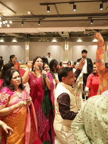 The energy is high as the family dances and celebrates during the Mayra. I am right there with them, cheering them on with the mic.