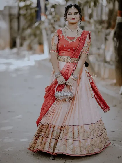 For the Makara Sankranthi festival, I designed this exquisite Zari Kota lehenga for my client. The peach skirt with a traditional border is paired with a red brocade blouse, creating a vision of grace and tradition.