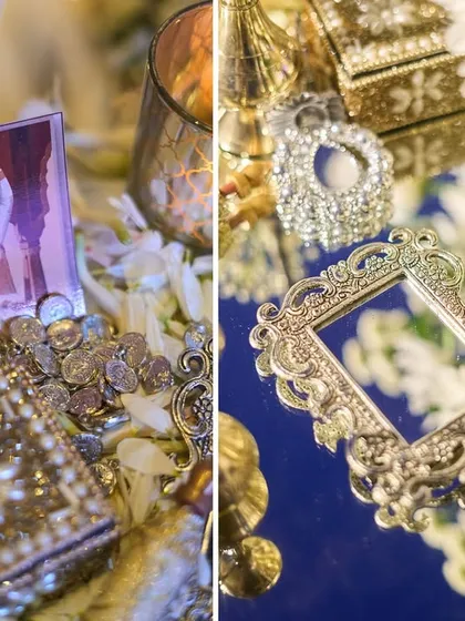 Intricate details like a jeweled box and a handheld mirror, scattered among flower petals, add to the opulence and storytelling of the event.