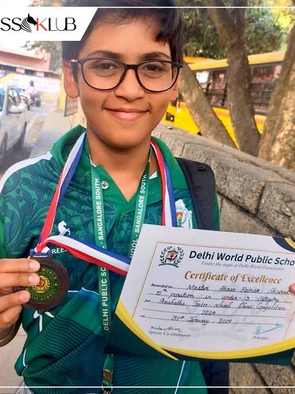 A close up of Ahaan, beaming with pride as he shows off his medal and certificate of excellence. It is these moments that fuel our passion for teaching chess to kids.