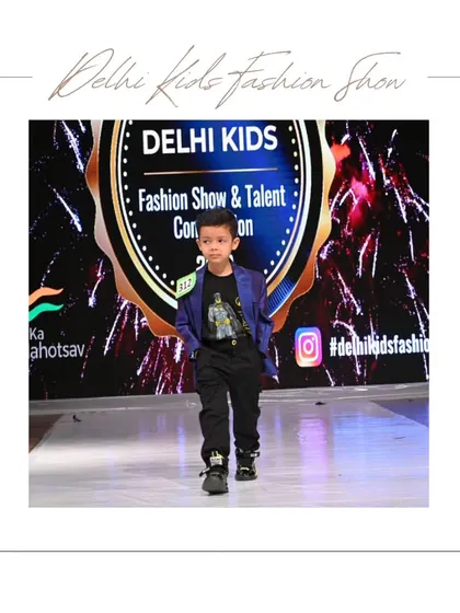 This young model owns the runway in a cool blue blazer and graphic tee. It's a perfect example of the "smart casual" style that many boys love to showcase.