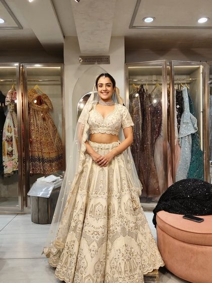 This bride looks radiant and happy in an ivory and gold lehenga. Our goal is to make every client feel their best on their special day.