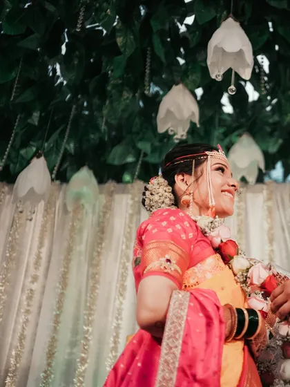 A low-angle shot of the bride smiling radiantly during her ceremony. We use creative angles to find the most flattering and interesting perspectives.