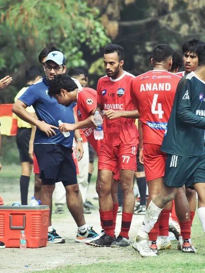A coach attending to a player during a break, highlighting our focus on player welfare and fitness management.