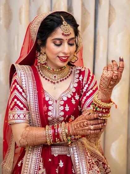 Another shot of this beautiful bride, highlighting the details of her red lehenga and the flawless makeup application.
