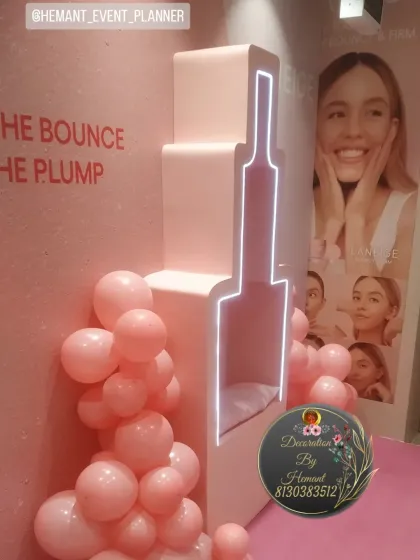 A side view of the custom-built photo booth for the beauty brand Laneige. The neon lighting inside the bottle-shaped prop creates a beautiful glow, making it an attractive feature for the event.