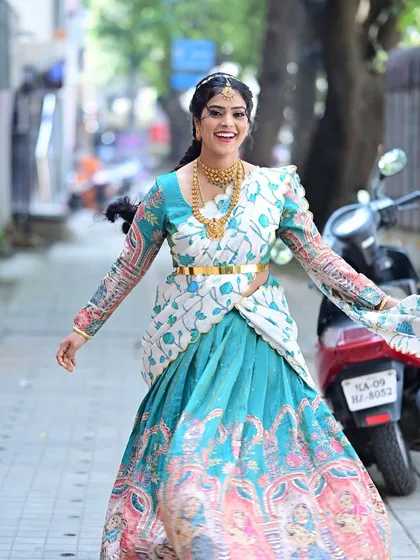 Preethi looking happy and radiant. This full-length shot showcases her entire look for her daughter's naming ceremony.
