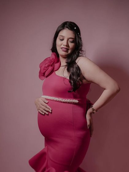 Our client looking radiant in the pinkish-red Gabriel gown. The form-fitting scuba fabric and dramatic ruffles create a stunning mermaid silhouette.