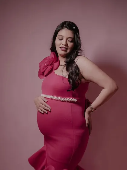 Our client looking radiant in the pinkish-red Gabriel gown. The form-fitting scuba fabric and dramatic ruffles create a stunning mermaid silhouette.
