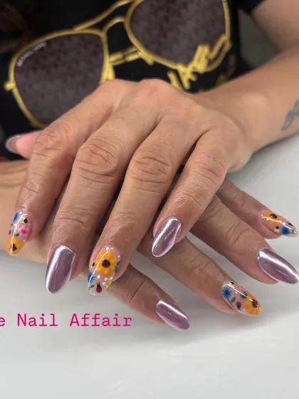 A full view of the purple chrome and sunflower nail art set.