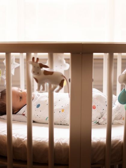 The first days at home are priceless. This shot captures a baby looking up at their mobile, a simple, everyday moment that you'll want to remember forever.