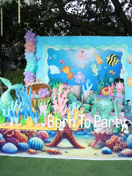 A massive and detailed underwater stage backdrop, featuring a coral reef, a mermaid tail, and various sea creatures.