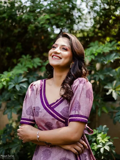 An uplifting and radiant portrait. The actress looks up with a wide, happy smile, bathed in beautiful natural light, creating a very positive and energetic image.