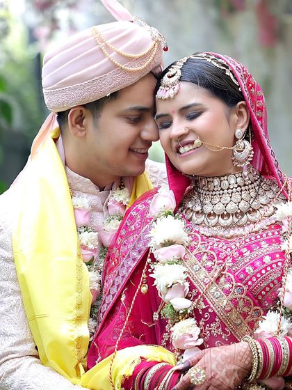 A tender and happy moment between the bride and groom, their faces close together. This candid shot perfectly captures the love and joy of the wedding day.