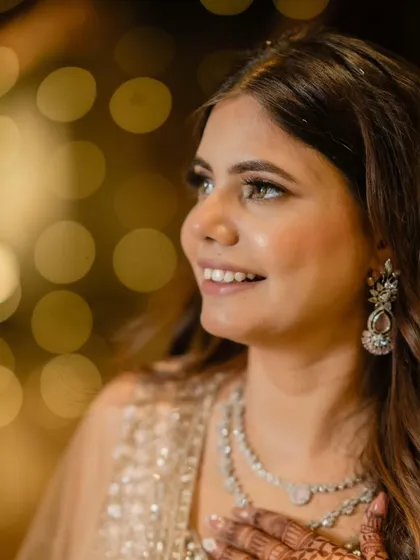 A close-up of the bride-to-be, with the bokeh lights creating a magical background. Her glowing skin is the star of the show.