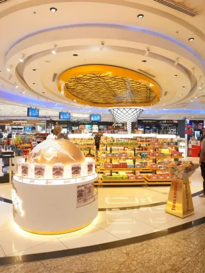 This wide-angle photograph captures the grand scale and intricate design of the Adani Ospree Duty-Free store at Mumbai International Airport. Our commercial space photography aims to present a comprehensive view that highlights architecture, branding, and customer experience.