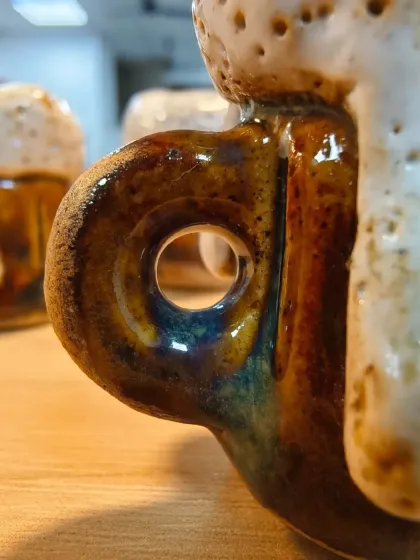 The handle of this tiny beer mug shows the beautiful effects of glazing. The way the colors melt and blend in the kiln is a magical part of the ceramic process that we teach in our courses.