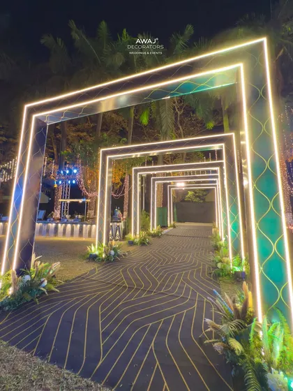 For a modern and high-energy Sangeet night, I created this futuristic entrance tunnel using geometric frames with integrated LED lighting, guiding guests into a night of celebration.