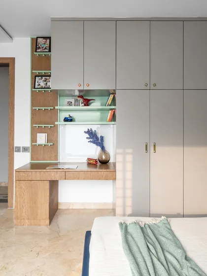 The integrated study desk and wardrobe unit, shown here in the morning light. The design maximizes space while maintaining a clean and organized look.