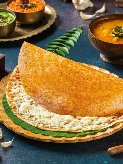 A close-up of the cheese dosa, emphasizing the texture of the dosa and the gooey cheese filling.