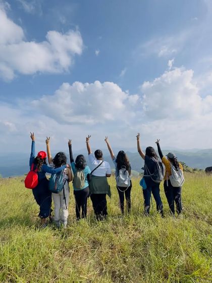 A group celebrating at the summit of Narasimha Parvatha.