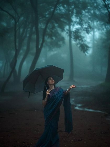 Another pose with the umbrella from the monsoon series, showing a different angle.