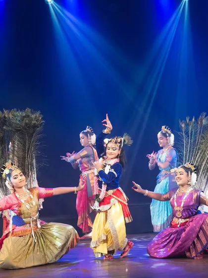 A beautiful formation from "KRISHNA", where dancers use large peacock feathers as props to evoke the imagery associated with the Lord. The coordination and visual symmetry are key elements of our choreography.