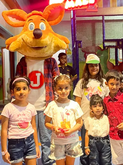 A group of kids posing with J the Fox during our Independence Day celebration, a day filled with patriotic fun.
