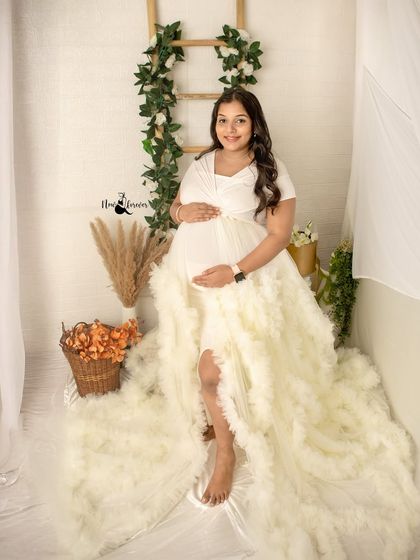A full-length portrait showing the beautiful cascade of the white gown. We have a range of gowns in the studio so you can find the perfect style that makes you feel amazing.