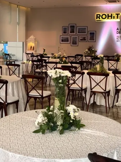 Another view of the corporate event setup, highlighting the beautiful floral centerpieces and the overall sophisticated ambiance I created overnight.