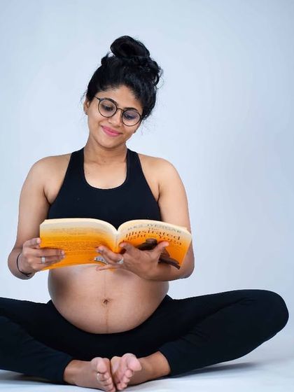A quiet moment of preparation. This mom-to-be is captured reading a book, a simple and sweet portrait that speaks to the journey of motherhood.