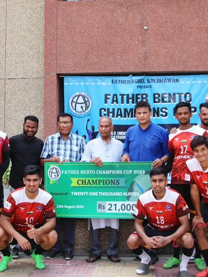 Receiving the trophy and prize money for the Father Bento Champions Cup.